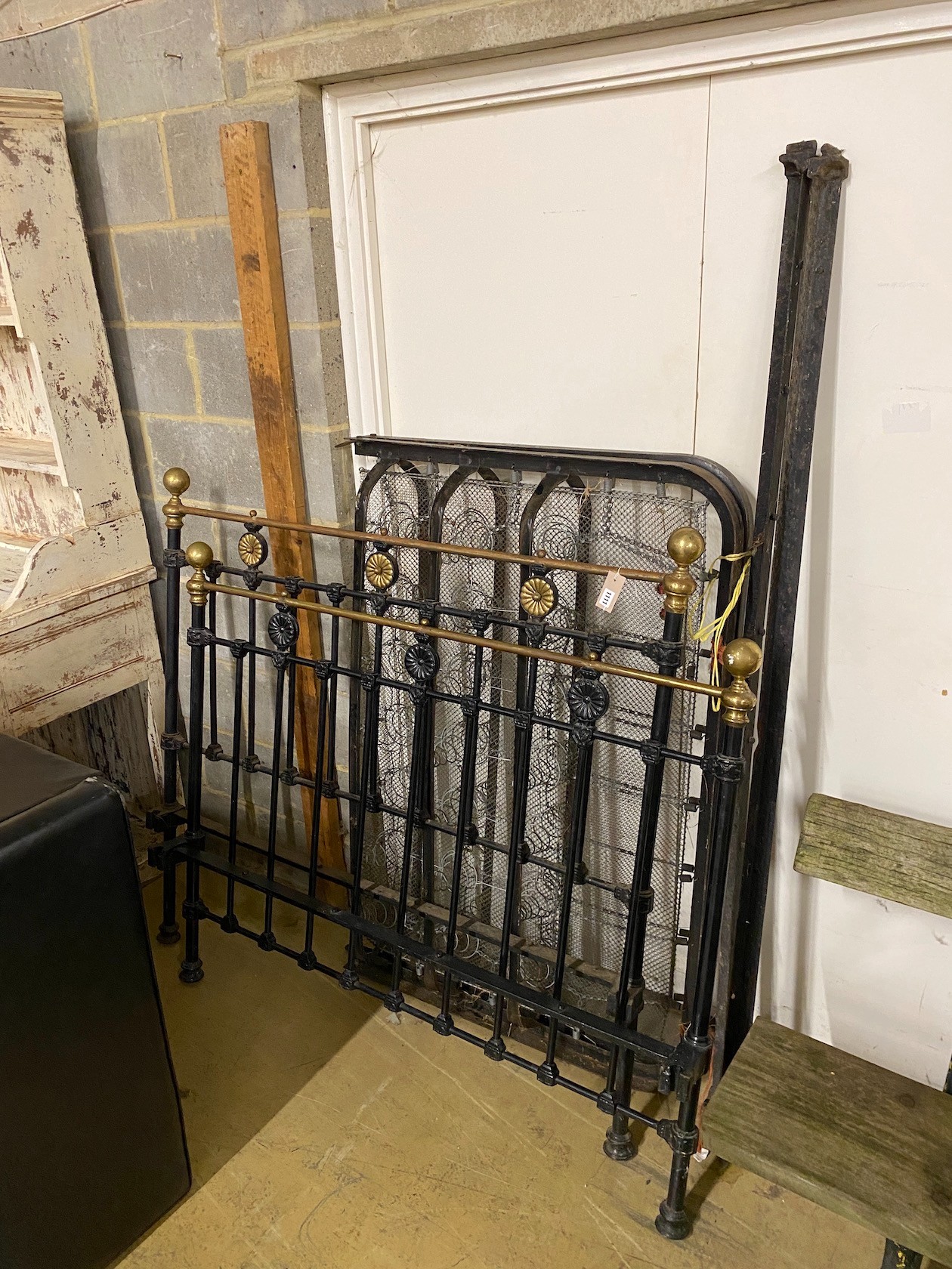 A Victorian cast iron and brass mounted bed frame, width 136cm, height 130cm